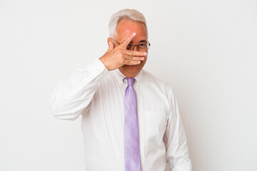 Senior american man isolated on white background blink at the camera through fingers, embarrassed covering face.