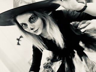 Witch with sugar skull makeup and black hat