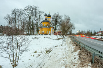 The church stands by the road that runs through the village