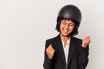 Young mixed race business woman wearing a motorbike helmet isolated raising fist after a victory, winner concept.