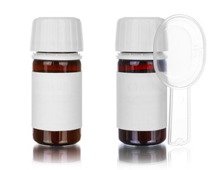Medicine syrup bottle with spoon isolated on white