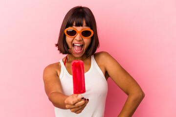 Young mixed race woman eating and licking an ice cream isolated