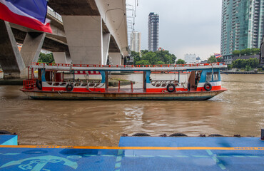 Fototapeta na wymiar a ferry boat cross the Chao Phraya River at the Sathorn Pier in Bangkok Thailand Southeast Asia