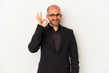 Young business bald man isolated on white background  cheerful and confident showing ok gesture.