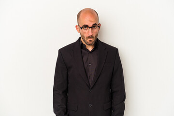 Young business bald man isolated on white background  shrugs shoulders and open eyes confused.