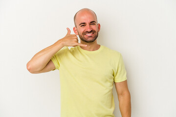 Young bald man isolated on white background showing a mobile phone call gesture with fingers.