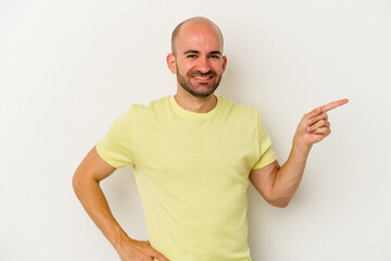 Young bald man isolated on white background smiling cheerfully pointing with forefinger away.