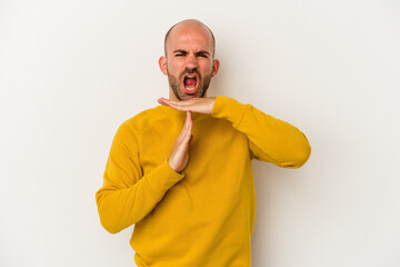 Young bald man isolated on white background showing a timeout gesture.