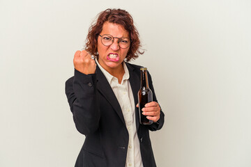 Middle age latin business woman holding a beer isolated on white background showing fist to camera, aggressive facial expression.