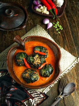 Buntil Daun Pepaya Jepang, a traditional Indonesian dish from Central Java. Filled with a mixture of grated coconut, anchovies, lamtoro and spices, wrapped in papaya leaves, in a spicy coconut sauce.
