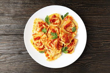 Delicious food concept with ravioli on wooden table