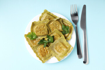 Delicious food concept with ravioli on blue background