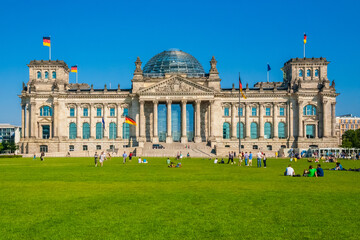 Gorgeous view of the western side of the famous Reichstag building with lawn in Berlin which houses...