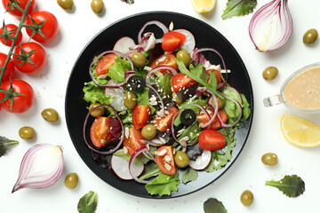 Concept of tasty food with vegetable salad with tahini sauce on white background