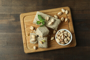 Fototapeta premium Concept of tasty food with halva on wooden background