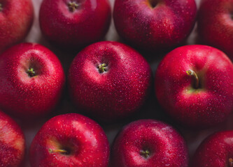 Top view of large wet ripe scarlet apples. A rich harvest of delicious healthy fruits. Proper nutrition. Diet and vegetarianism.