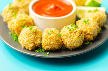 Roast chicken bites with tomato dip, chopped and shaped cooked chicken breast with a roast chicken flavour seasoning in breadcrumbs