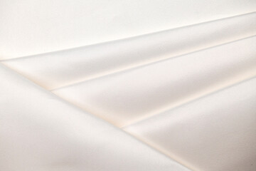 Background, texture. Template. Satin cloth for wedding and evening dresses. A nude shade.