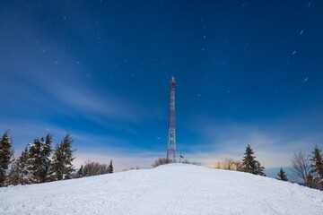 Cellular tower against background starry night sky