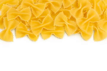 Obraz premium Bow tie pasta isolated on white background with clipping path and full depth of field. Top view with copy space for your text. Flat lay.