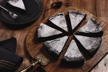 Kladdkaka. Traditional Swedish moist chocolate cake on wooden table. Fika. Hygge