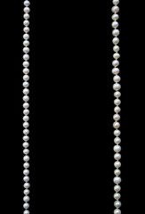 White pearls on the black silk as background