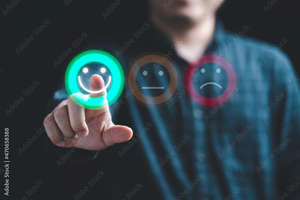Poster Businessman using smartphone for select smiley face icon for client evaluation and customer satisfaction after use product and service concept.