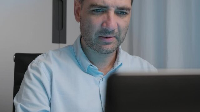 Dolly shot, laptop foreground professional businessman tired of working remotely from Home