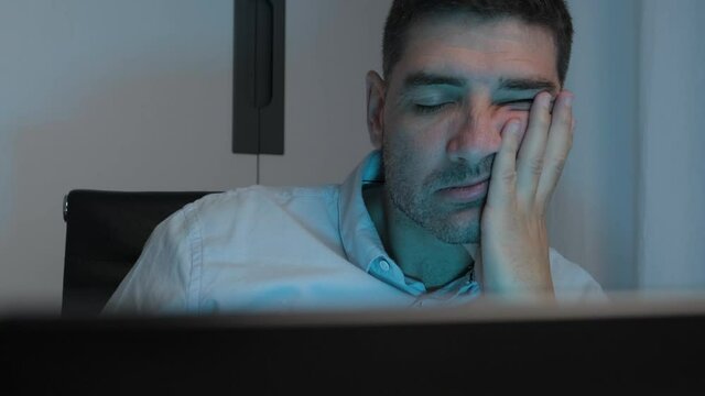 Close up adult male fall asleep during remote Working time from Home office, dolly shot
