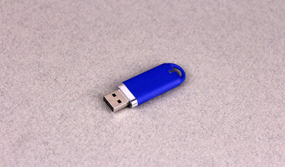 Blue flash drive on gray background. Usb drive