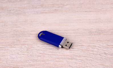Blue flash drive on wooden background. Usb drive