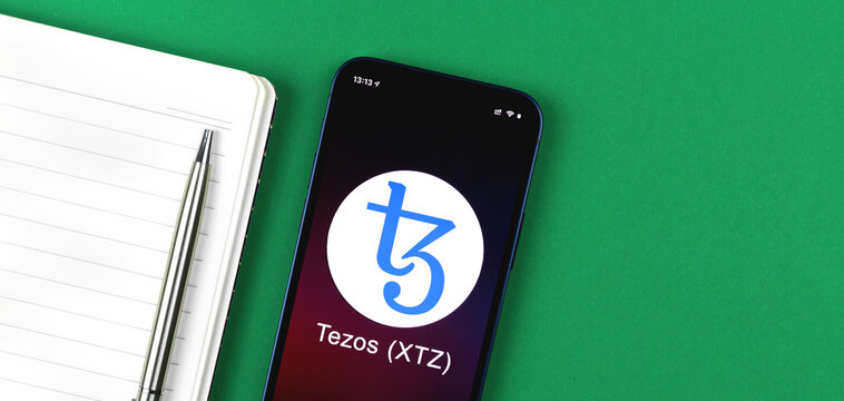 Tezos XTZ symbol. Trade with cryptocurrency, digital and virtual money, banking with mobile phone concept. Business workspace, banner, table top view photo