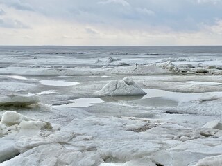 landscape of ice and snow on the shore of the bay