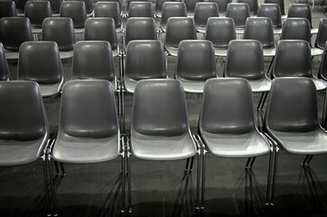 Obraz premium monochromatic image of gray empty audience seats arranged in rows selective focus