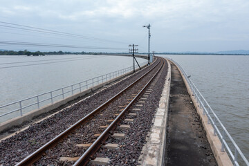 Fototapeta na wymiar railway bridge above the reservoir of Pa Sak Jolasid dam at Lopburi, amazing Thailand i.