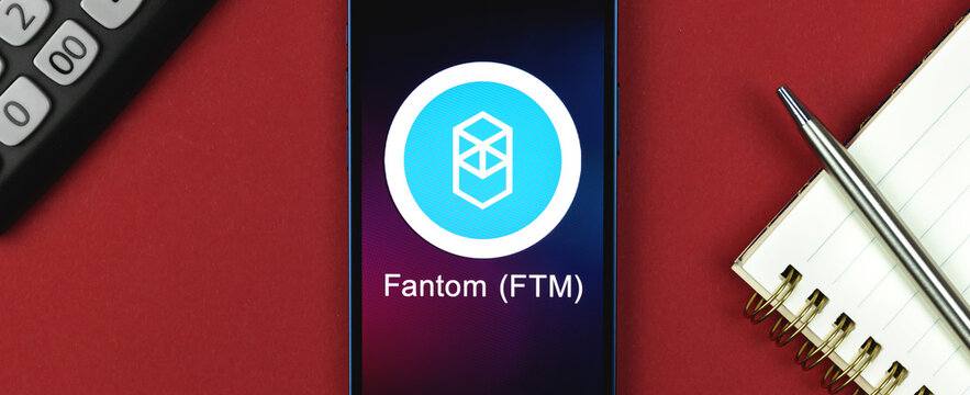 Fantom FTM symbol. Trade with cryptocurrency, digital and virtual money, banking with mobile phone concept. Business workspace, banner, table top view photo
