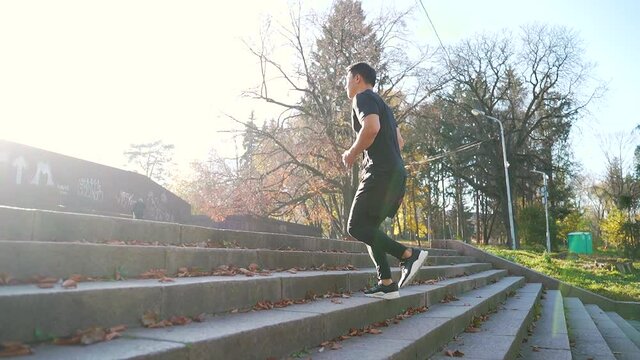 young asian man athlete Sportsman feet running up stairs training intense cardio workout exercise male runner legs jogging on steps in urban city background. Fitness Cardio Endurance Exercise