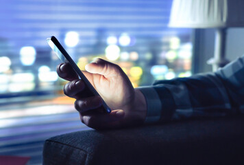 Phone with fraud text message, unknown scam call or night texting. Man using smartphone. Anonymous...