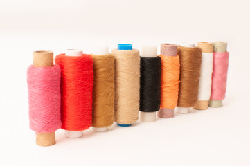 Threads of Warm shades on a white background.