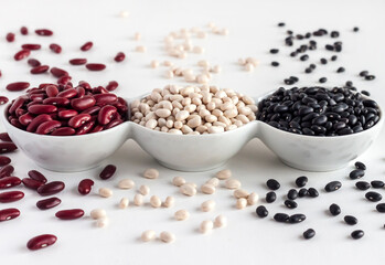 Assortment of beans in a white bowl on white background