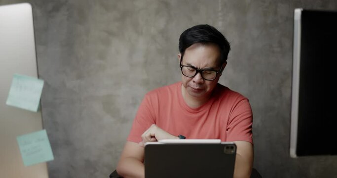 Middle-aged Asian businessman wearing glasses feel exhaustion and stress from working overtime. Not getting enough rest can affect  inefficient work. stress disorder from hard work. failure of thought