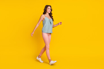 Fototapeta na wymiar Full size profile side photo of young attractive woman happy positive smile go step meeting isolated over yellow color background