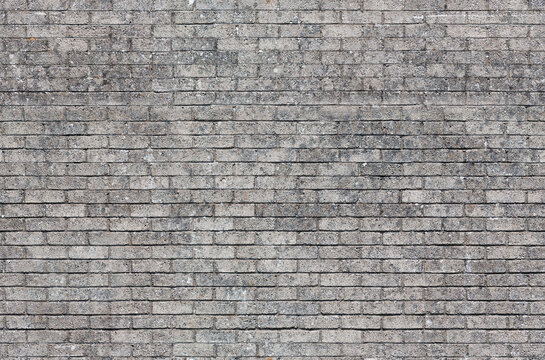 Fototapeta Repeating gray brick wall texture typically found in developed areas. The image is a loop ready seamless texture file, allowing the picture to be tiled and used as an infinite scrolling background.