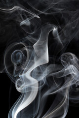 abstract white smoke swirls on black background

