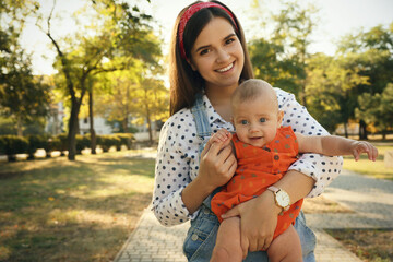 Portrait of young mother with her cute baby in park on sunny day - Powered by Adobe