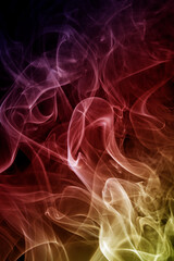 Abstract colorful smoke swirls on black background