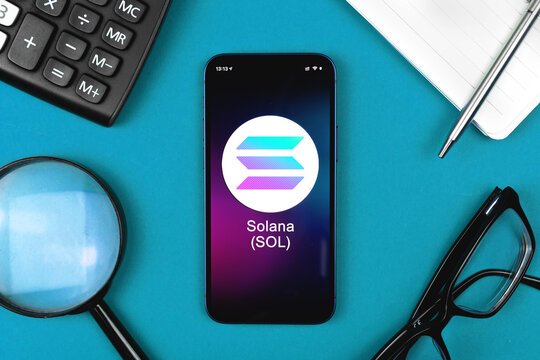 Solana SOL symbol. Trade with cryptocurrency, digital and virtual money, banking with mobile phone concept. Business workspace, table top view photo