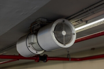 Fan in modern building Parking in door. Parking building ventilation system. blower flow air for...
