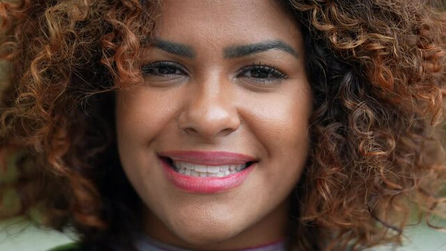 Brazilian woman smiling close-up face. Black hispanic girl smile