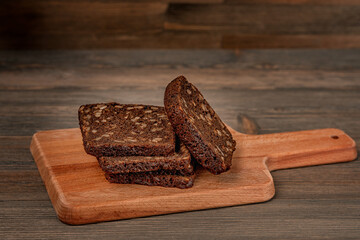 Multi-grain black bread on a wooden board